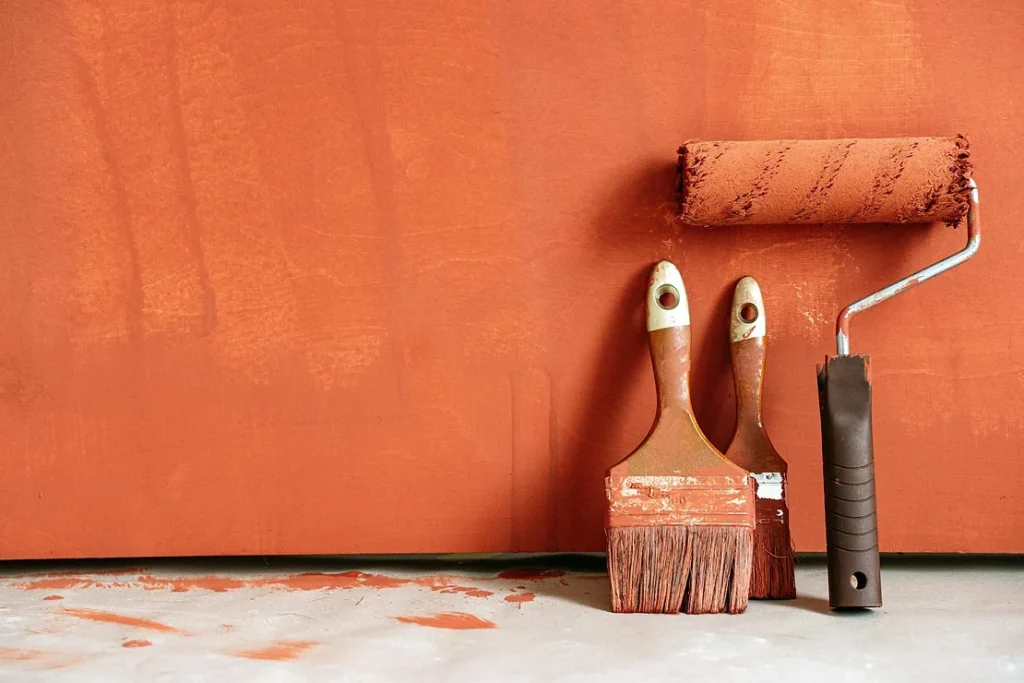 painting a wall with blood orange paint
