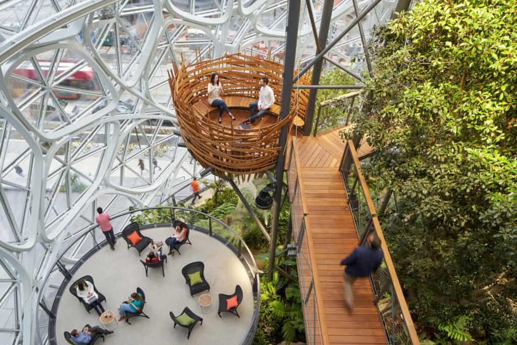 Woven timber bird's nest meeting pod and plank walkway above a circular lounge terrace inside the Amazon Spheres