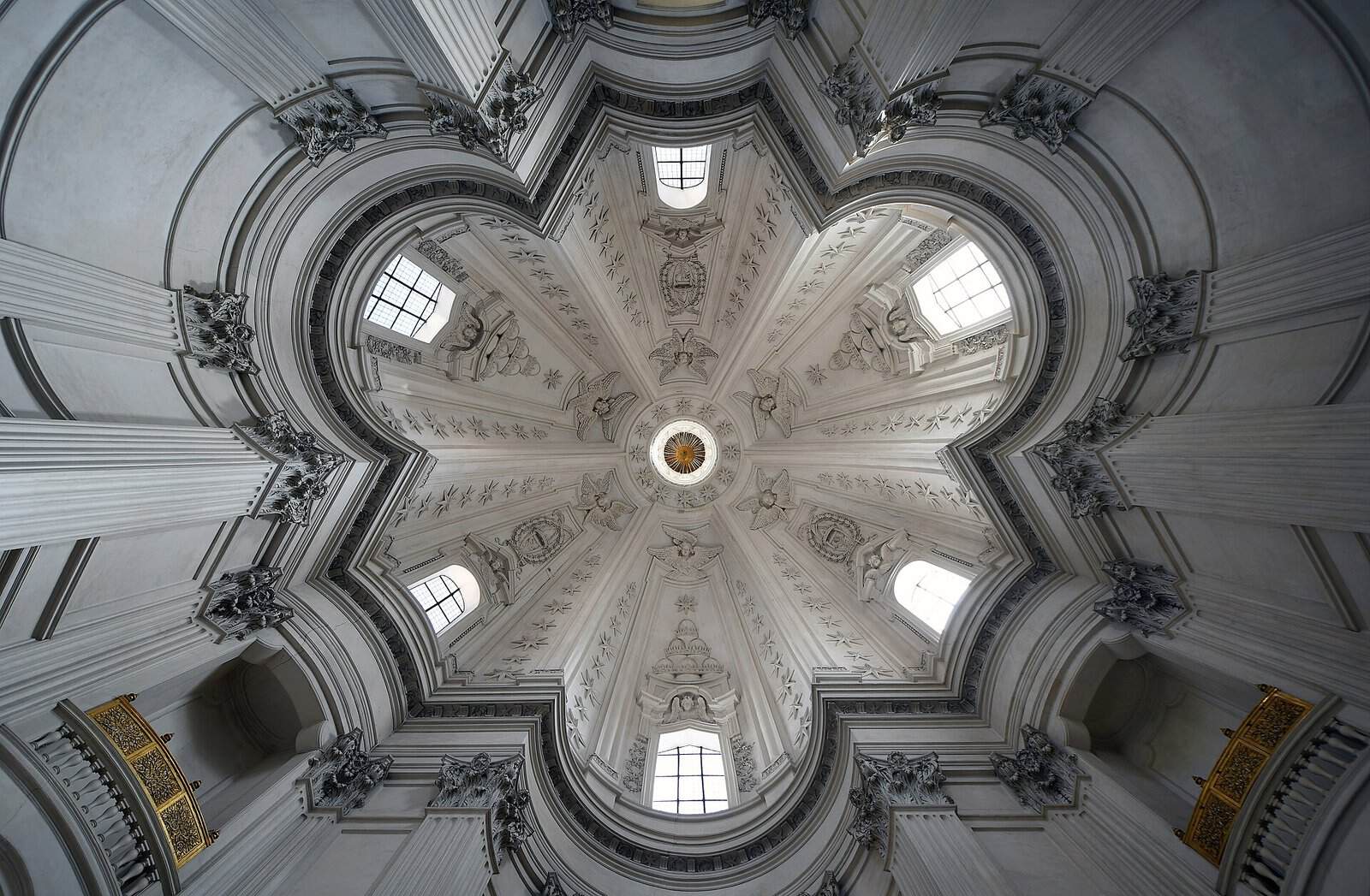 Looking straight up into the white star-shaped dome of Sant'Ivo alla Sapienza in Rome, its six lobes rising to a small round lantern