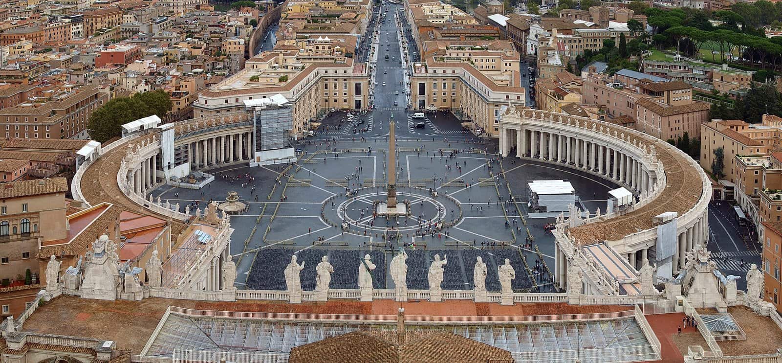 Aerial view from the dome of St Peter's Basilica over St Peter's Square, with Bernini's two curved colonnades wrapping the oval piazza around the central obelisk