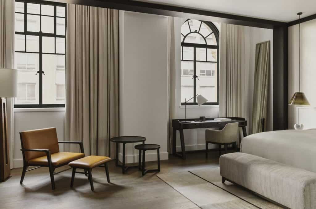 Heritage-level guest room at Capella Sydney with steel-framed windows, writing desk and leather lounge chair