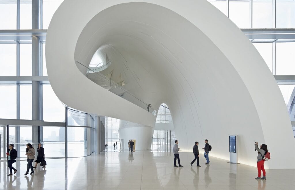 Swirling white atrium ramp with glass railings inside the Heydar Aliyev Center