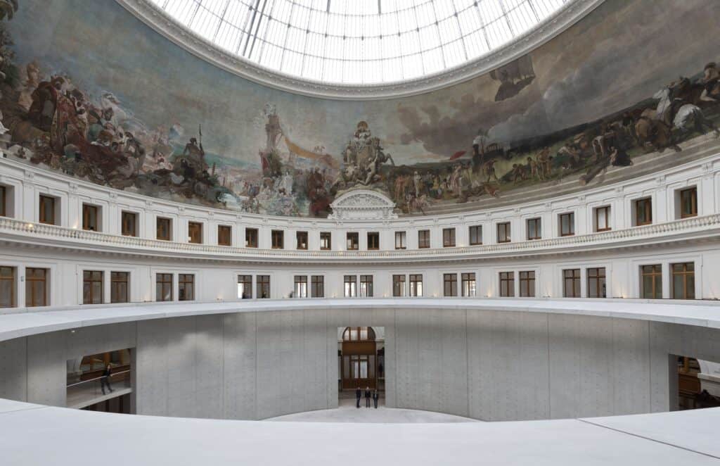 Concrete cylinder inside the rotunda of La Bourse de Commerce beneath the painted dome mural