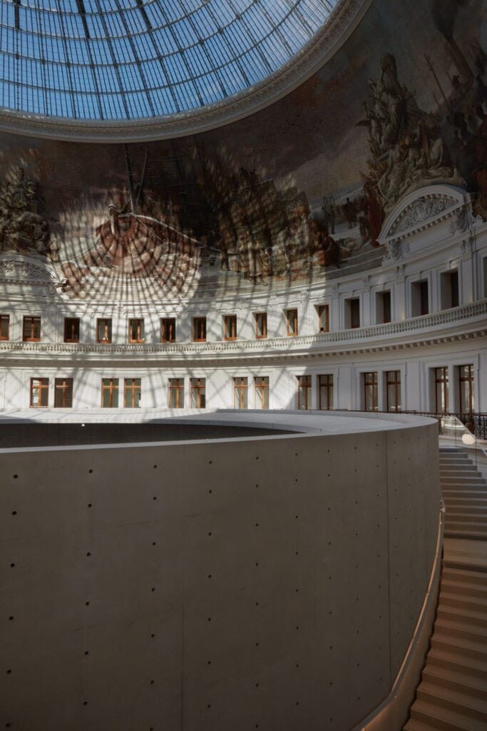Dome mural above the concrete cylinder and stairs inside La Bourse de Commerce